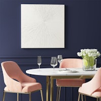 a dining room with pink chairs and a blue wall