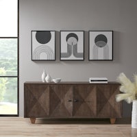 a modern sideboard in a room with two framed pictures
